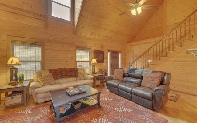 600 Mill Ridge Rd, Hiawassee, GA 30546 - living room with wood finished floors, ceiling fan, wooden walls, high vaulted ceiling, and stairway
