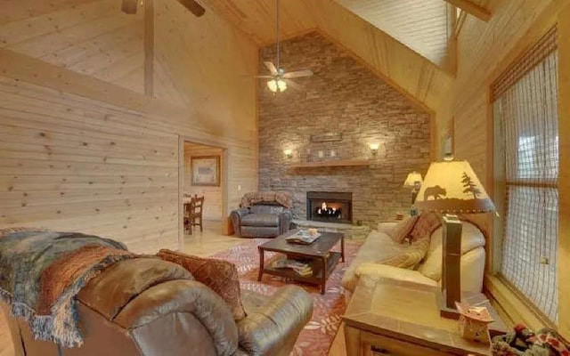 600 Mill Ridge Rd, Hiawassee, GA 30546 - living room featuring a stone fireplace, a ceiling fan, wood walls, and high vaulted ceiling