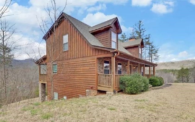 600 Mill Ridge Rd, Hiawassee, GA 30546 - view of side of home featuring board and batten siding and covered porch
