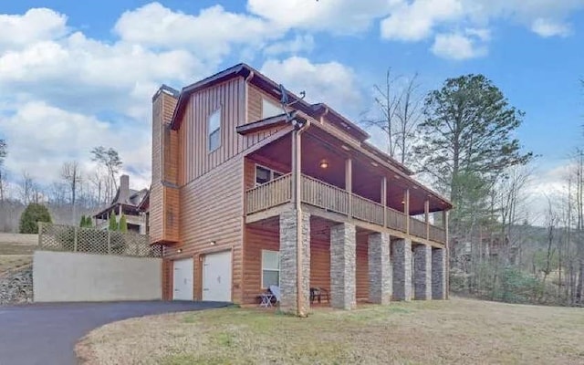 600 Mill Ridge Rd, Hiawassee, GA 30546 - view of side of home with an attached garage, a chimney, driveway, and a balcony