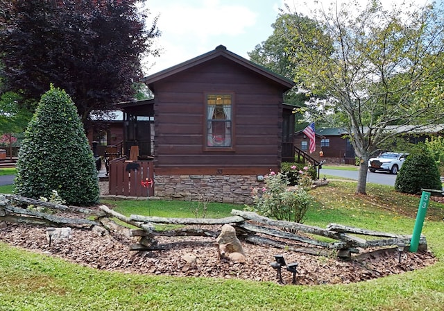 view of side of property with a yard