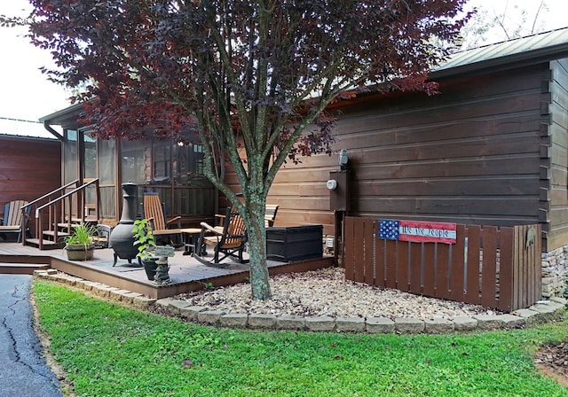 view of yard with a deck and a sunroom