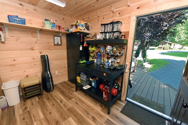 interior space featuring wood walls, wood ceiling, and hardwood / wood-style floors