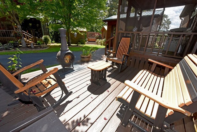 wooden terrace featuring a sunroom