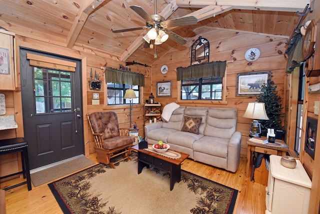 living room with light wood-type flooring, vaulted ceiling with beams, wood walls, and wood ceiling