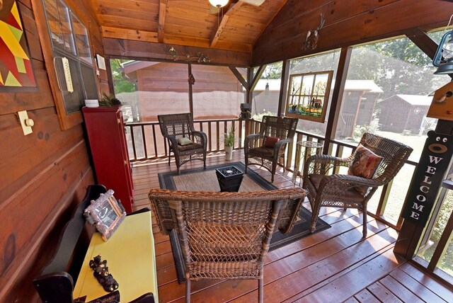 sunroom with wooden ceiling, a healthy amount of sunlight, and lofted ceiling