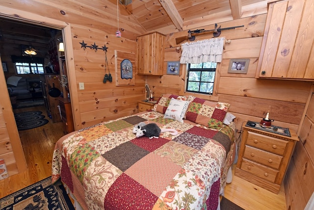 bedroom featuring wood walls, vaulted ceiling with beams, hardwood / wood-style flooring, and wood ceiling