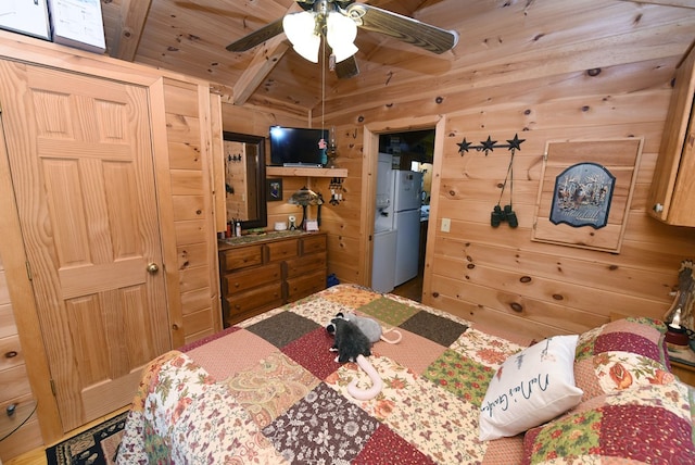 bedroom featuring wood walls, white refrigerator, wood ceiling, and ceiling fan