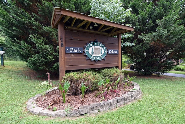 community / neighborhood sign with a lawn