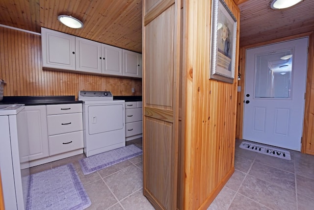 laundry area with wood ceiling, wooden walls, and cabinet space