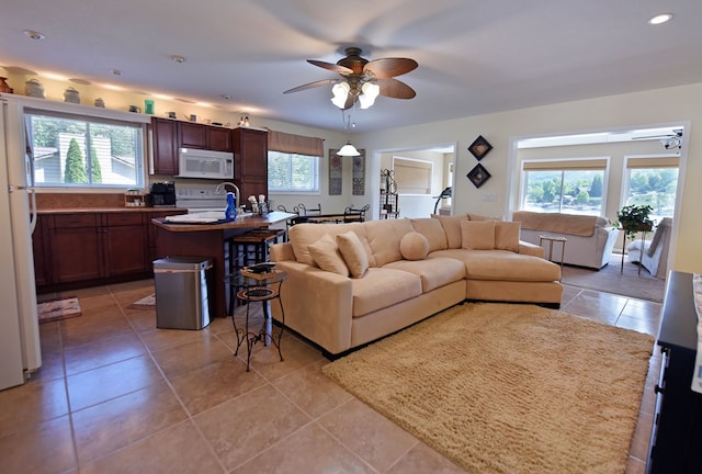 living room with ceiling fan, recessed lighting, and light tile patterned flooring
