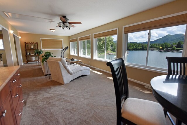 carpeted bedroom with baseboards and a water and mountain view