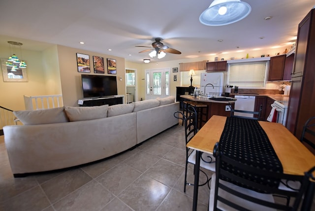 tiled living room with ceiling fan, a sink, and recessed lighting