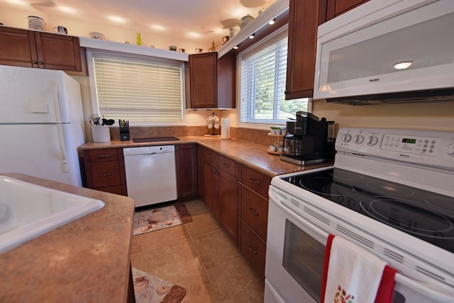 kitchen with white appliances, light countertops, and light tile patterned floors