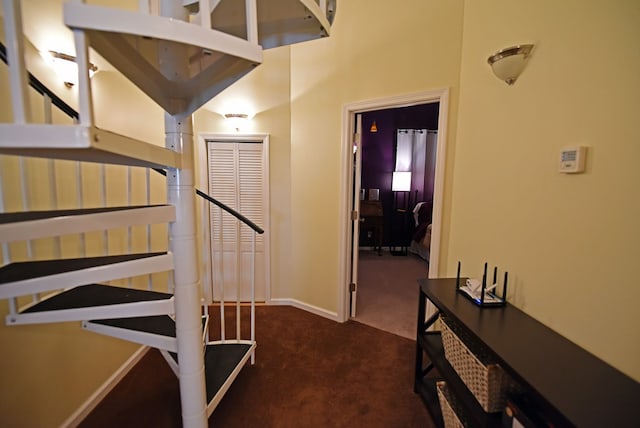 staircase with baseboards and carpet floors