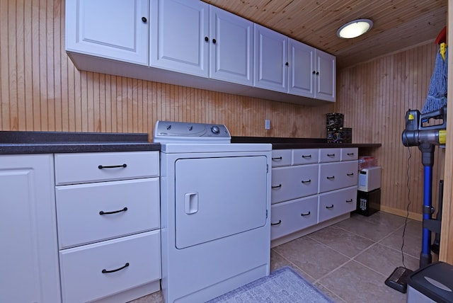 laundry room featuring washer / clothes dryer, tile patterned floors, wooden walls, cabinet space, and wood ceiling
