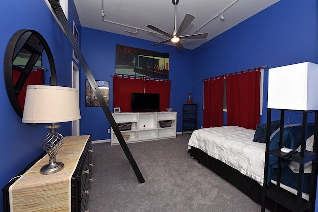 carpeted bedroom featuring track lighting, ceiling fan, and visible vents