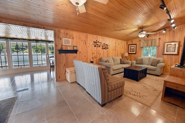 tiled living room featuring rail lighting, plenty of natural light, wood ceiling, and a ceiling fan