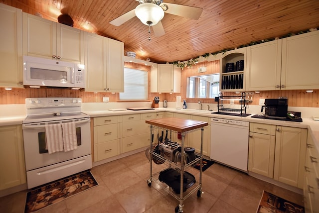kitchen featuring wooden ceiling, a sink, light countertops, ceiling fan, and white appliances