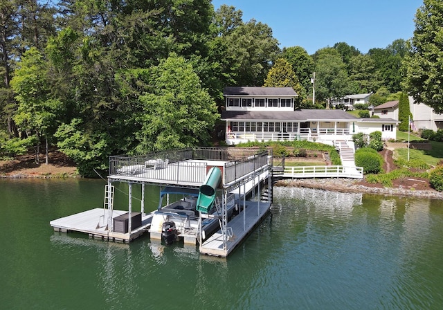 view of dock featuring boat lift, stairway, and a water view