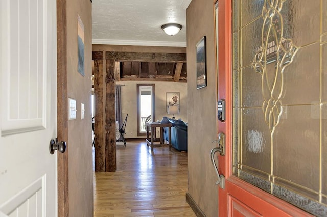 corridor with ornamental molding and wood-type flooring