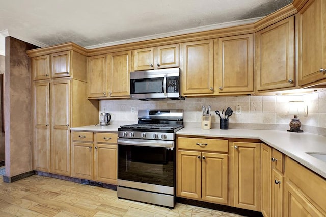 kitchen featuring light hardwood / wood-style floors, tasteful backsplash, appliances with stainless steel finishes, and ornamental molding