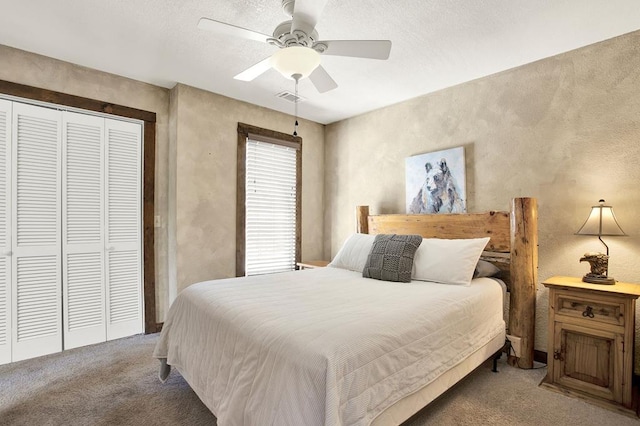 carpeted bedroom featuring a closet and ceiling fan