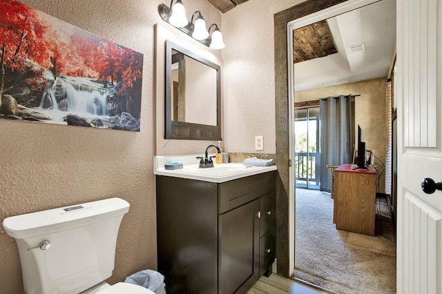 bathroom featuring toilet and vanity