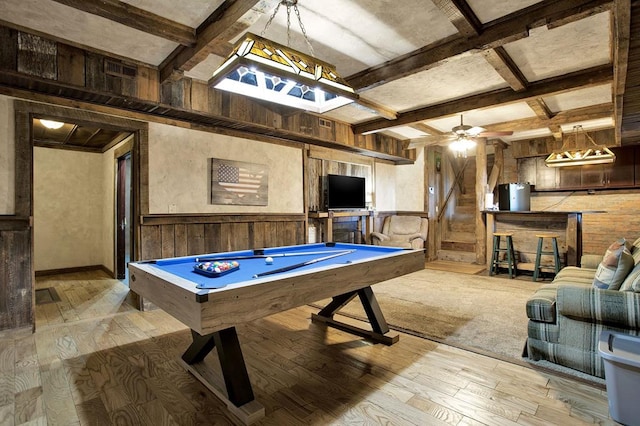 game room with beam ceiling, wooden walls, pool table, and light hardwood / wood-style floors