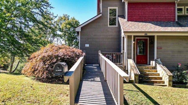 view of exterior entry with a yard