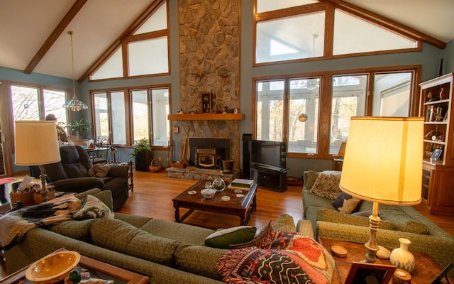 living room with hardwood / wood-style flooring, high vaulted ceiling, a chandelier, and beamed ceiling