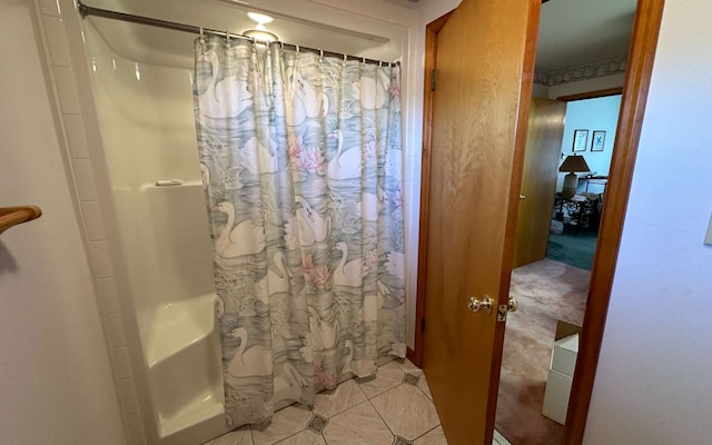 bathroom with tile patterned floors and walk in shower