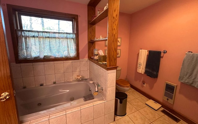 bathroom with a relaxing tiled tub, heating unit, tile patterned floors, and toilet