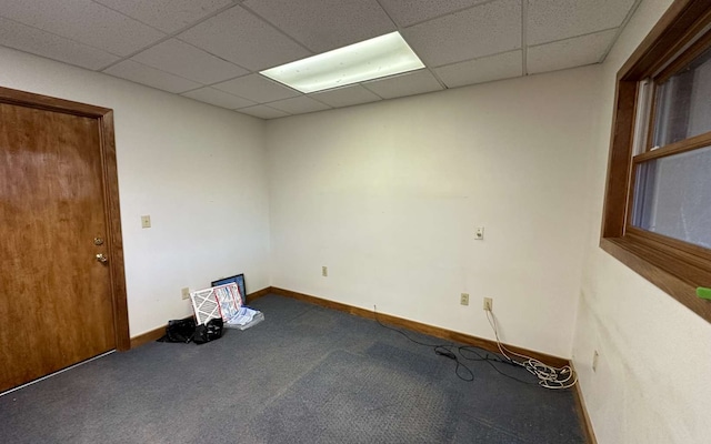 spare room with a drop ceiling and carpet floors