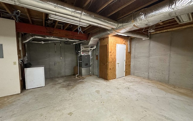 basement with washer / clothes dryer and heating unit