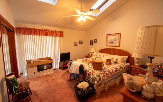 bedroom with carpet floors, a skylight, high vaulted ceiling, and ceiling fan