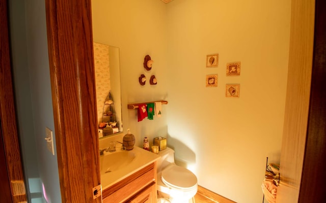 bathroom featuring vanity and toilet