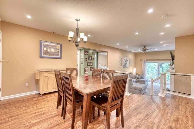 dining space featuring ceiling fan with notable chandelier, light hardwood / wood-style floors, and a textured ceiling