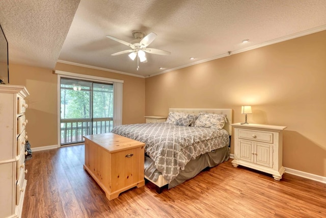 bedroom with ceiling fan, crown molding, hardwood / wood-style floors, and a textured ceiling