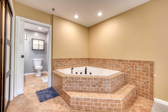 bathroom with tiled tub and toilet