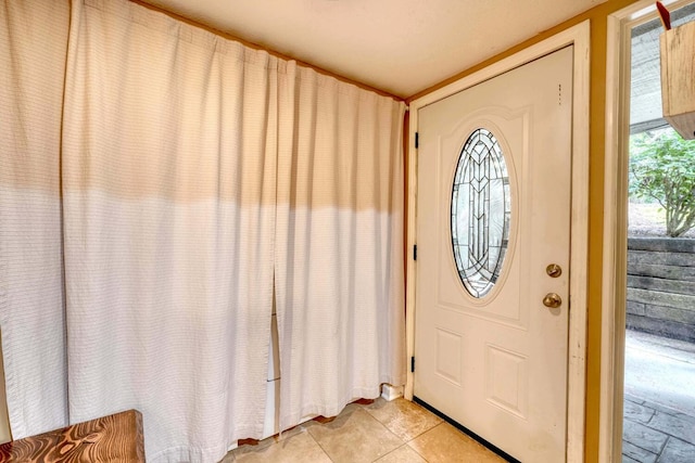 tiled foyer entrance featuring a textured ceiling