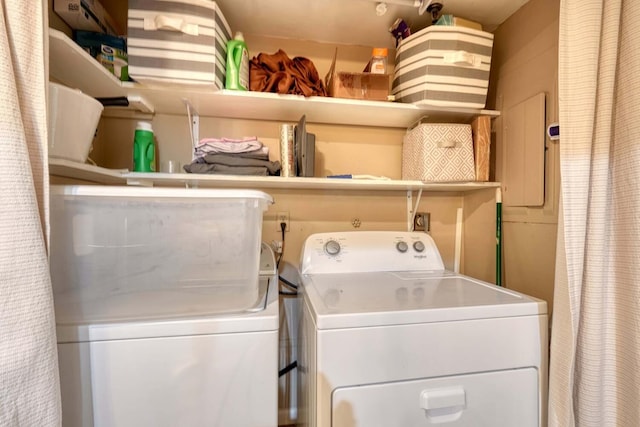 clothes washing area featuring washing machine and clothes dryer