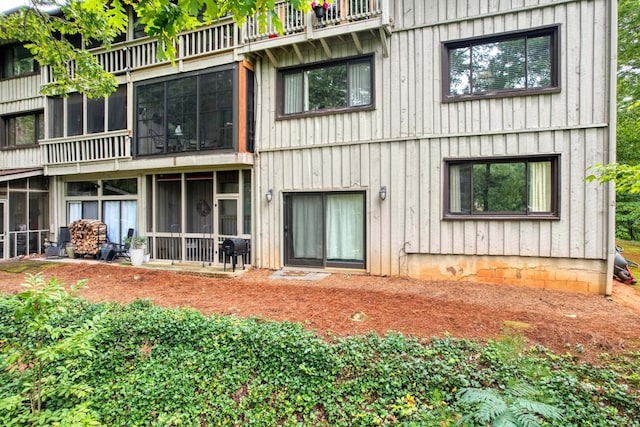 rear view of property with a balcony