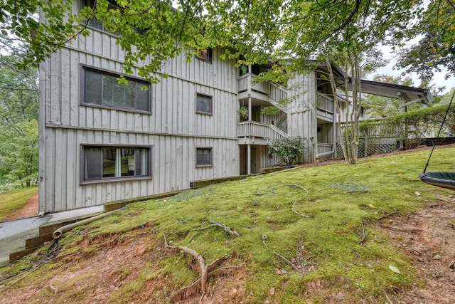 exterior space featuring a balcony and a lawn