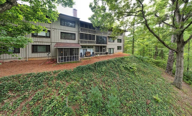 back of house with a sunroom