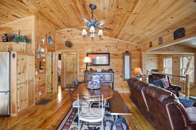 dining space with wood-type flooring, lofted ceiling, and wooden ceiling