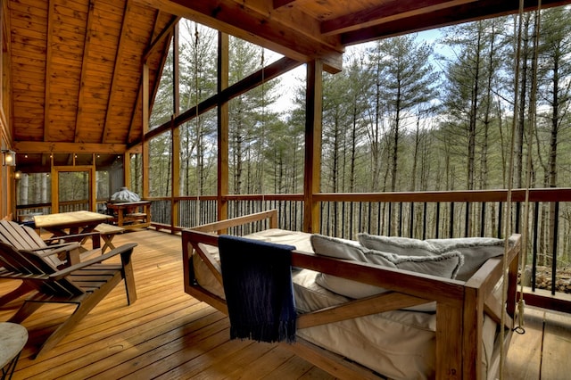 sunroom with lofted ceiling with beams and wood ceiling