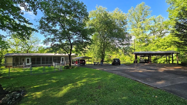 5451 Sampson Rd, Young Harris, GA 30582 - view of grassy yard featuring a carport, driveway, and a sunroom