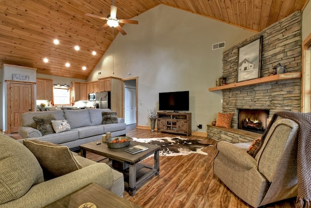 living room with ceiling fan, wood-type flooring, wood ceiling, and high vaulted ceiling