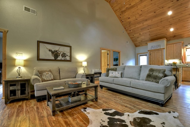 living room with wood ceiling, high vaulted ceiling, and light hardwood / wood-style floors